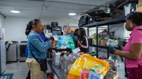 Volunteers on Saturday helping assemble boxes and meals for distribution.