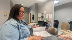 Tina Hickman, of Choctaw, Mississippi, flips through the course catalog for Bay Mills Community College, the tribal college she attended to earn her bachelor’s degree.