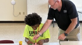 Joe Brinley of IBEW Local 26 instructs a high school student on LED circuits.