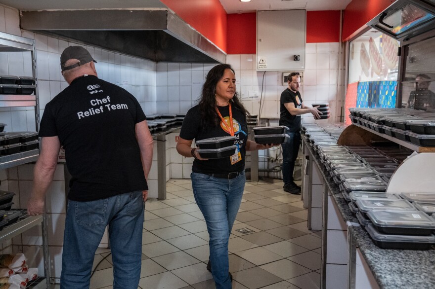 Zomi Frankcom works with colleagues and volunteers to unload and arrange for distribution lunch casseroles <a href="https://www.npr.org/2022/04/12/1091916421/russia-ukraine-war-refugees-romania">at Gara de Nord railway station in Bucharest</a> on April 6, 2022. The Australian aid worker was among those killed by an Israeli strike in Gaza.