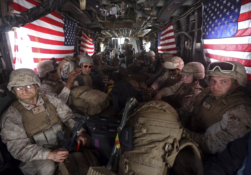 Marines onboard a helicopter at Kandahar Air Field upon the end of operations for the Marines and British combat troops in Helmand.