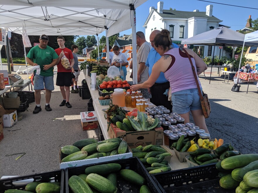 Visitors look over produce at a stand at the Old Town Farmers Market on July 20. The Belleville market started accepting SNAP benefits this year.