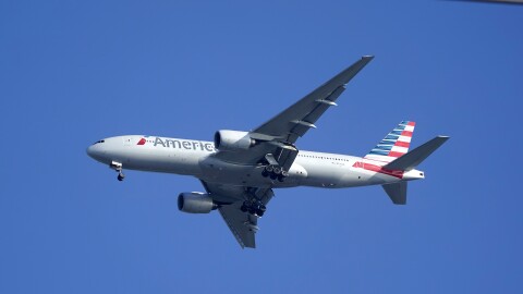 FILE - An American Airlines Boeing 777 is framed by utility wires as it prepares to land at Miami International Airport, Wednesday