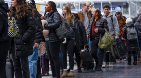 Travelers wait in line to check-in for their flights at the United Airlines Terminal 1 ahead of the Christmas Holiday at O'Hare International Airport.