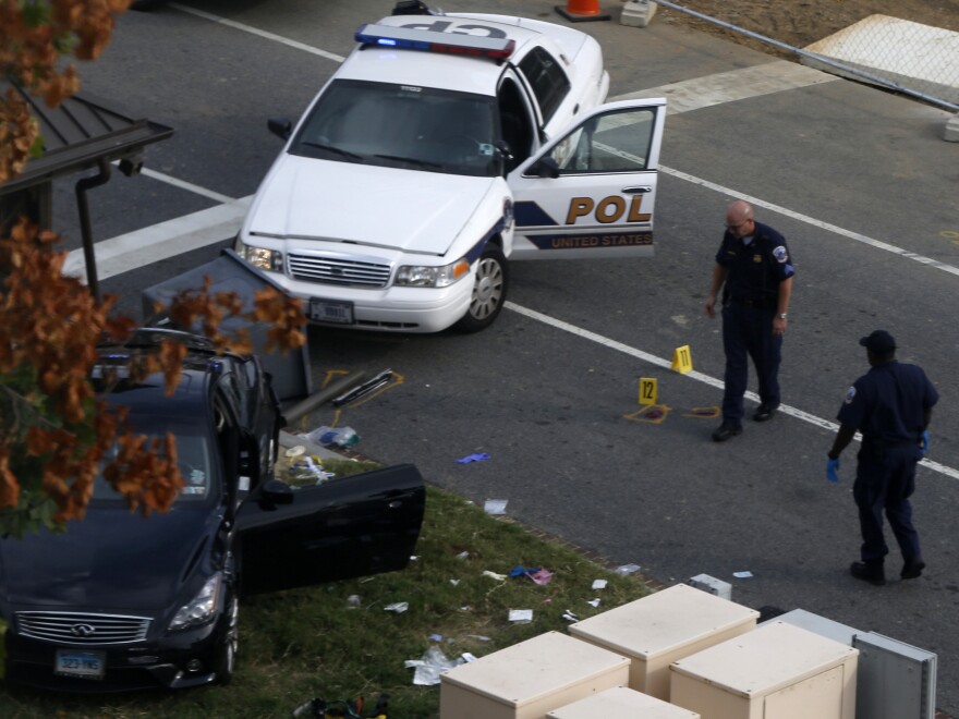 Capitol Hill police officers look at a car belonging to Miriam Carey after she was shot and killed on Oct. 3 following a high-speed car chase that started near the White House.