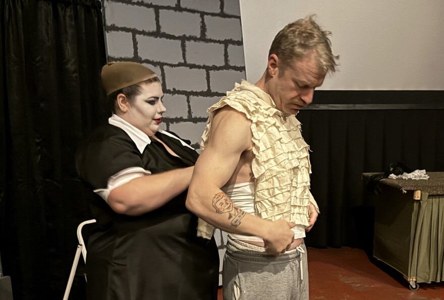 Courtney Vinzant (left) helps Bill Baker (right) get ready for their shadow cast production of "The Rockey Horror Picture Show" on Thursday, Oct. 29, 2026 near Soldotna, Alaska.