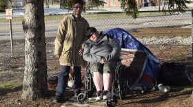 Lydia Nelson and fiancé Dennis Sullivan pose in front of a tent they have been ordered to vacate by Thursday.