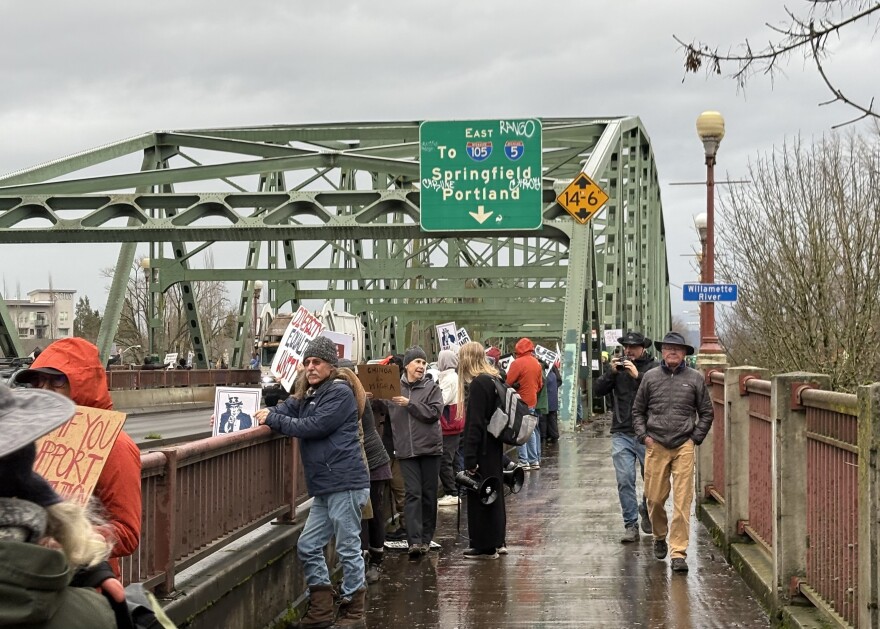 Community members gathered along the Ferry Street Bridge in Eugene on Dec. 18, 2025 to advocate for the contributions of migrants in Oregon.