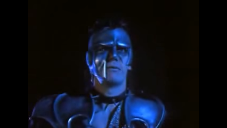 A man with blue armor and a mask