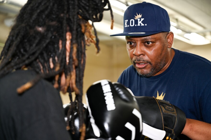 Rob Bell spars with a Knock Out Kings boxer at the East Bluff Community Center.