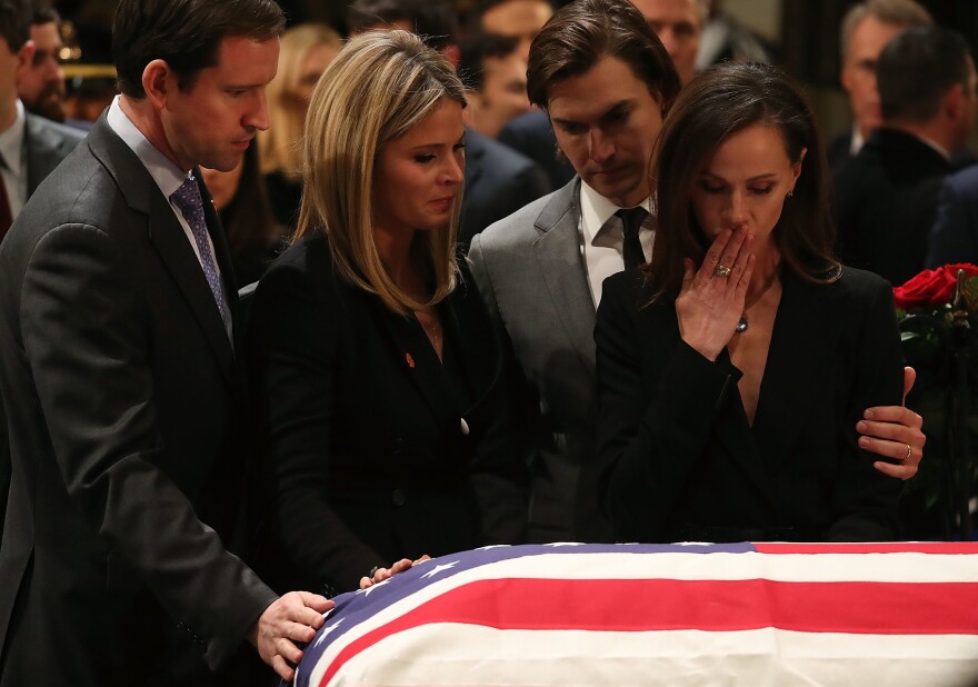 Jenna Bush Hager and her sister Barbara Bush stand with the husbands Henry Chase Hager, left, and Craig Coyne as they pay respect in front of the casket of the late former President George H.W. Bush as he lies in state in the U.S. Capitol Rotunda Tuesday in Washington, D.C.