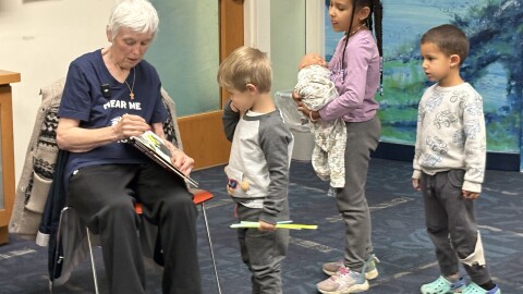 Jerri Thomas reads to children during the Hear me Roar story hour.