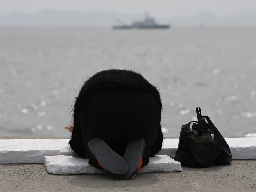 A prayer for the missing and dead: Family members and friends have gathered in the port city of Jindo, South Korea, as the search continues for the scores of passengers still missing after last Wednesday's ferry disaster. At the water's edge, many are offering prayers — including this woman.