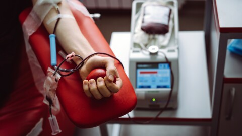 A man gives blood in a blood donation center