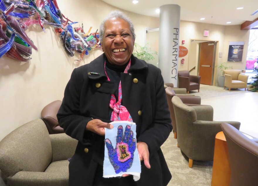 Nedra Bonds in the lobby at the University of Kansas Cancer Center in 2017, with one of her recent quilt pieces.