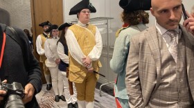 Colonial reenactors and political aides mingle in a hallway at the Sheraton Hotel in Nashua, October 13, 2023, during the New Hampshire Republican Party's FITN Leadership Summit.