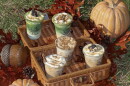 An autumn-styled setting with coffees in a basket