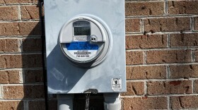 A grey metal box reading electricity usage on a home