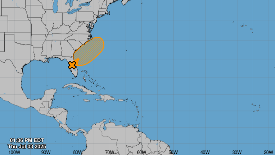 Blue background symbolizing the ocean with gray shapes symbolizing part of the U.S. that has part of central Florida highlighted in orange from northwest to northeast. 