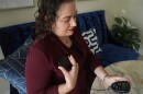 Brandy Ellis charges a pacemaker-like device that was installed in her chest as part of an experimental treatment for depression, on Thursday, July 24, 2025, in Delray Beach.