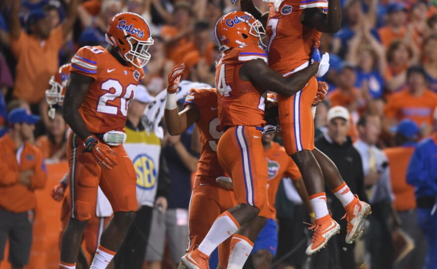 After Florida defensive back Marcus Maye (20) forces a fumble, defensive back Brian Poole (24) recovers and celebrates with his teammate Duke Dawson (7).