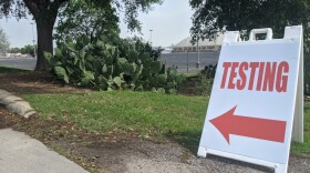 A sign directing people to testing at the Freeman Coliseum. 