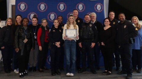 Mary Johns, a student at the University of Florida, receives the Police Service Award on Jan. 27, 2026, from employees of the UF campus police department for her help identifying a suspect in a series of sexual assaults near the campus. (UF Police Department/WUFT News)