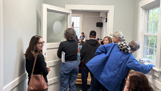 People spilled out of a select board public comment session on a potential data center in Bow, New Hampshire.