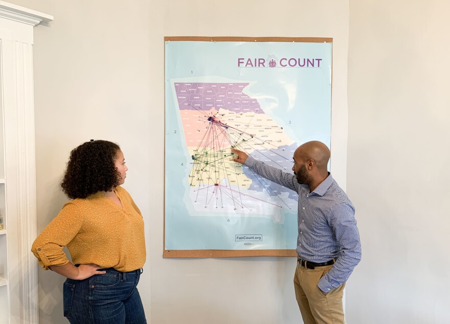 Ed Reed (right), Fair Count's program director, and Djemanesh Aneteneh, an operations and events administrator, look over a map showing the Wi-Fi hot spots the group has installed around Georgia.