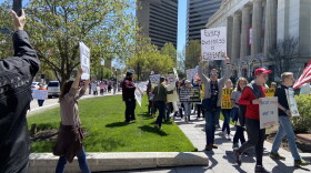 Protestors marched at the Statehouse on April 20, many carrying signs saying businesses should be able to reopen.