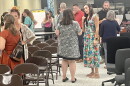 Parents of Pekin District 108 students chat Monday after a special school board meeting in the Washington Intermediate School cafeteria.