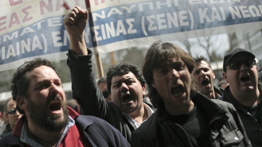 Shipyard workers demand their unpaid wages in central Athens on Thursday, the day that countries in the 17-nation euro zone formally approved a second bailout of $36.6 billion for Greece.