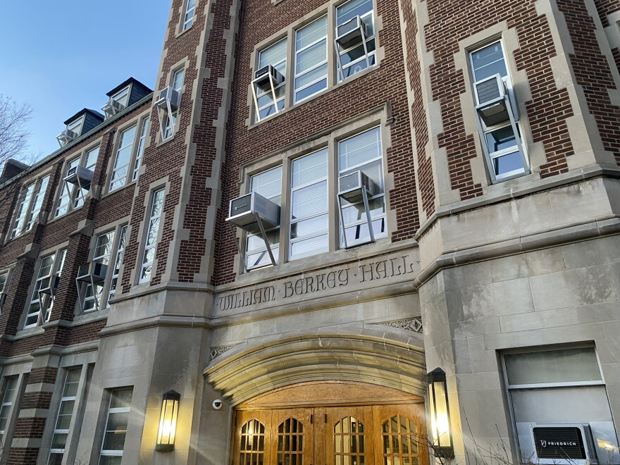Berkey Hall is seen with a dim sky and lights on the building turned on