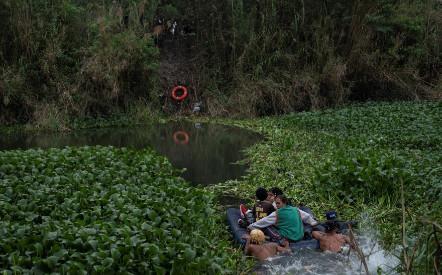 Asylum seekers cross the Rio Grande River into Brownsville, Texas, on Dec. 22.