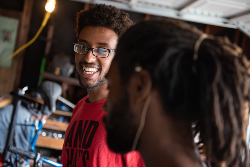Samson Terefe, left, laughs as he chats with Antonio Ballard, right, in The Biker Boyz & Girlz Shop in Indianapolis. (Lucas Carter for Here & Now)