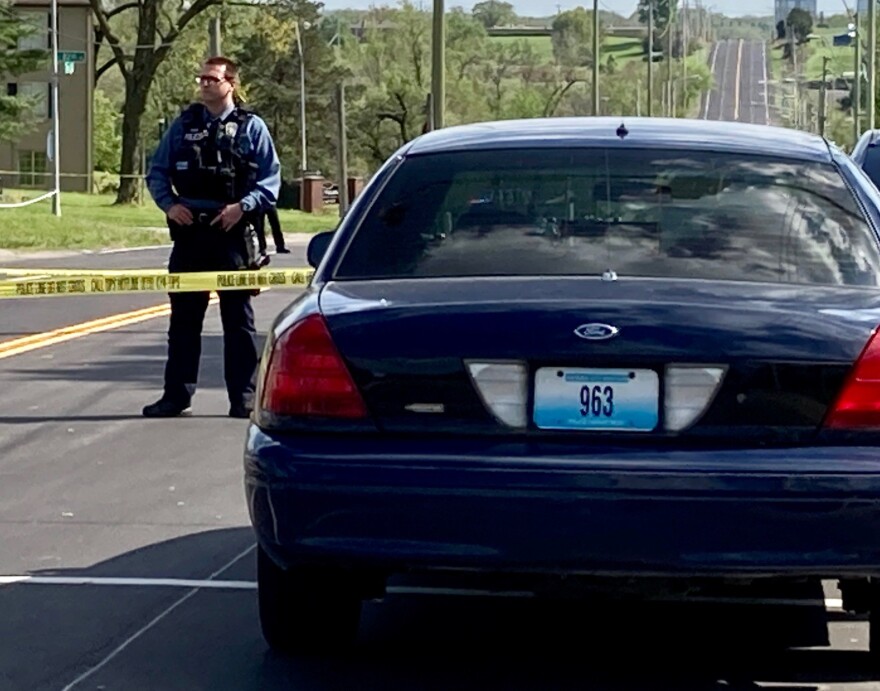 Police officer near police car at a crime scene.