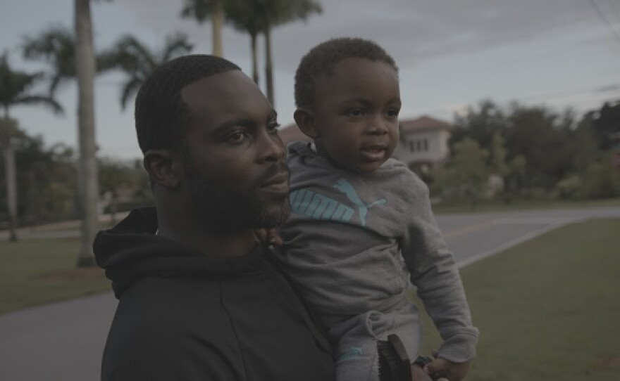 Michael Vick holds his young son.