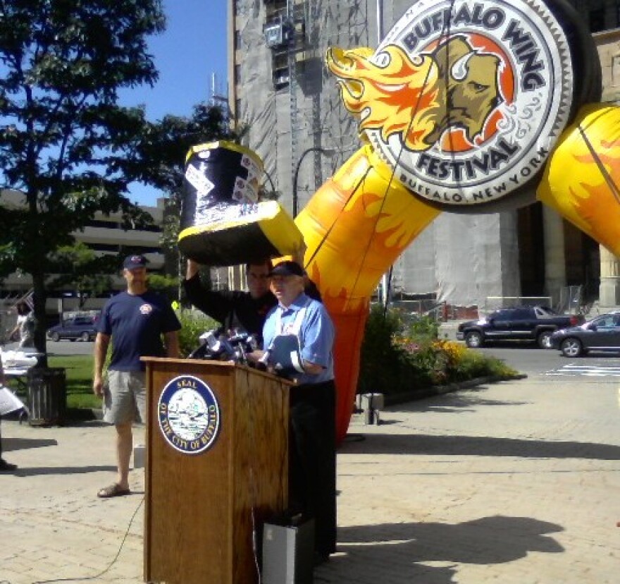 Buffalo fire union president Daniel Cunningham talks about collecting funds for fallen firefighters, Drew Cerza holds up large firefighter boot