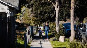 A mother and son walk through Stockton, California.