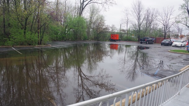 The partially flooded parking lot of a business complex on South Rose Street in Kalamazoo on Wednesday, April 15, 2026.