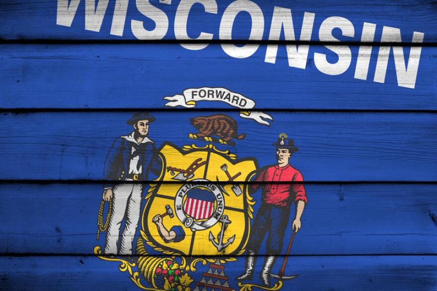 Wisconsin State Flag on wood background