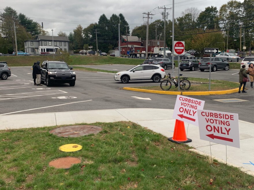 Some residents used curbside voting in Niantic on Tuesday but others were wary. “There’s a level of mistrust,” said volunteer Jackson Taylor. “They would prefer to put it in themselves.”