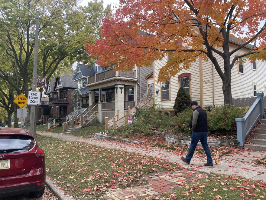 Ty Ash walks along First Street in Brewer's Hill among several duplexes. He first bought a duplex on this street after he graduated college a decade ago.