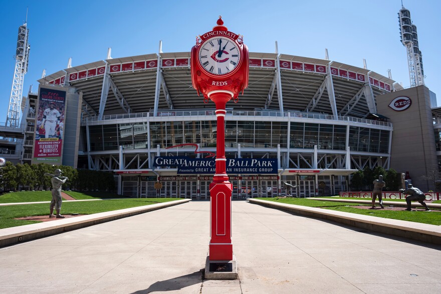 A red pedestal with a four-faced clock on top.