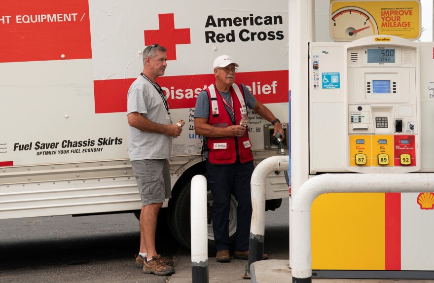 Red Cross Volunteers Ken Brown, left, and David Dempsey get gas after dropping off supplies at a shelter in Warm Springs, Ore., on July 20, 2026.