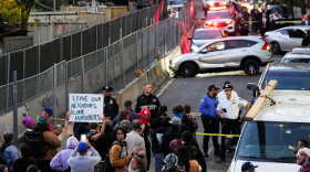 People gather at the scene of a shooting as law enforcement work the area Thursday, Oct. 8, 2026, in New York.