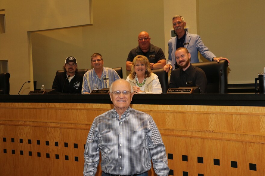 Thomas "Artie" Lucas with the Branson Board of Aldermen behind him