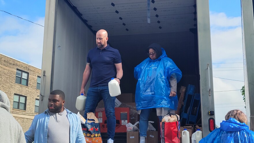 Volunteers distribute food and toiletries out of a truck in the parking lot of the Resource Council of WNY on May 16, 2022, two days after a mass shooting at the nearby Tops Market on Jefferson.