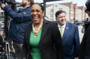 Juliana Stratton, wearing a green dress and black blazer, walks in front of Gov. JB Pritzker. Pritzker is endorsing Lt. Gov. Juliana Stratton’s bid for the U.S. Senate on April 25, 2025.