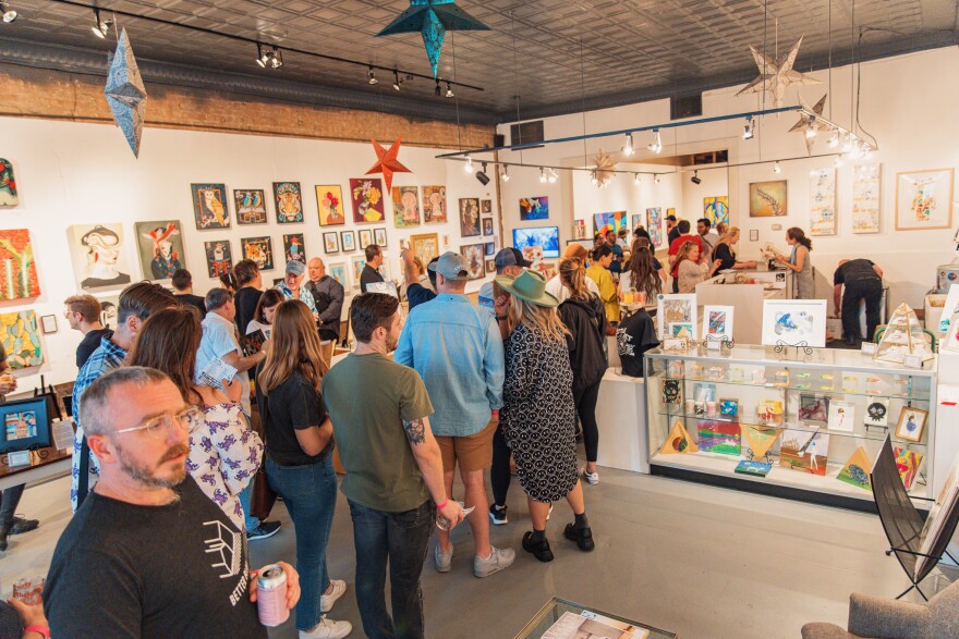 Visitors walk around Kettle Art Gallery during Deep Ellum's wine walk.